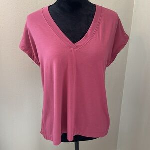 Athleta berry colored top in size XS/P with cross slit in back.
